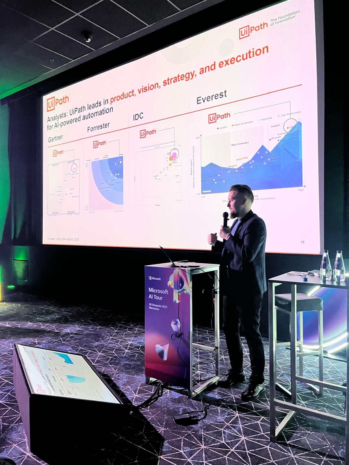 a photo of Piotr Zajac presenting on stage