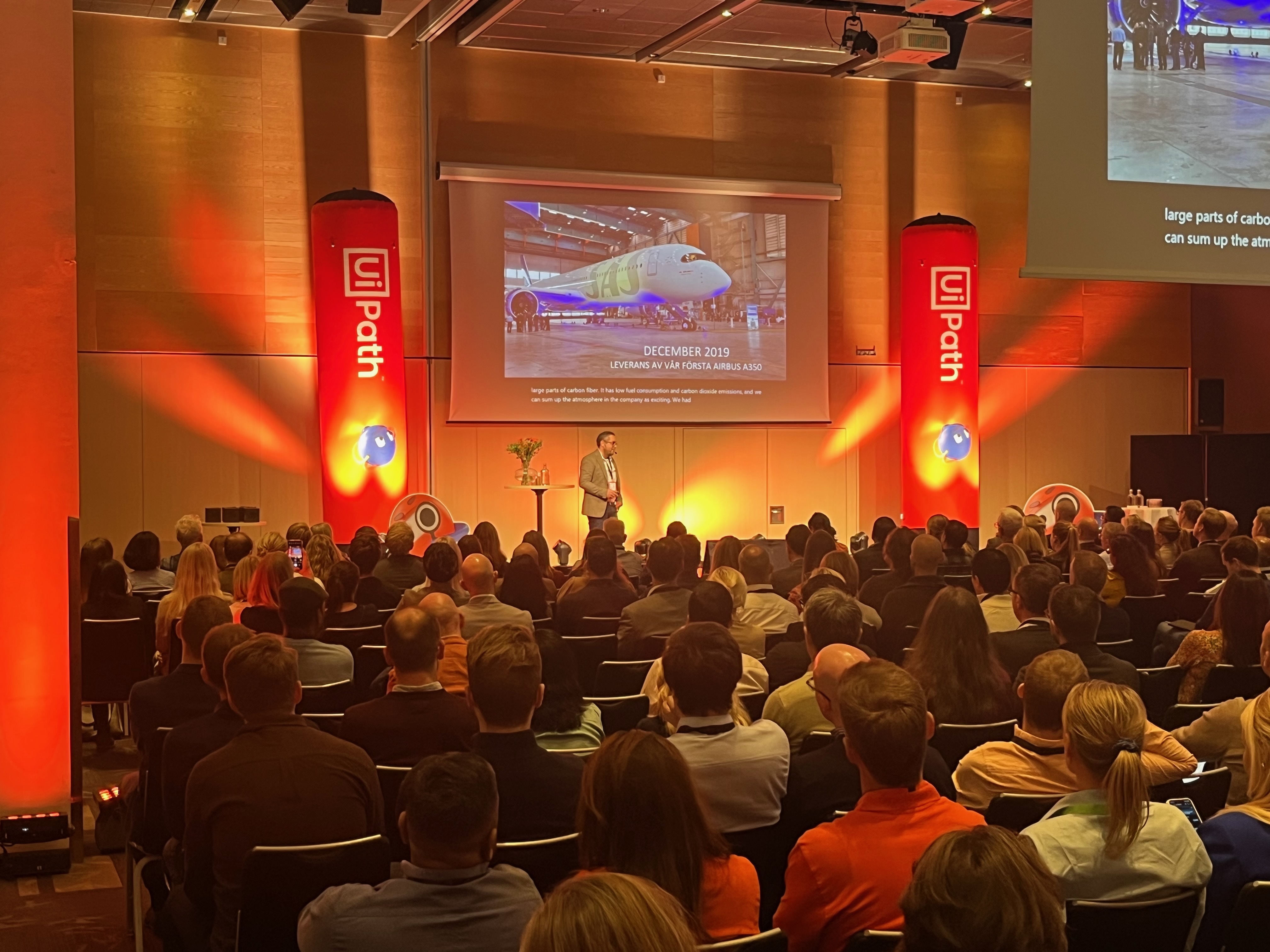 conference hall with many people seated in attendance