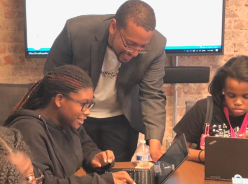 a photo of Robert Love volunteering at a Black Girls Code event
