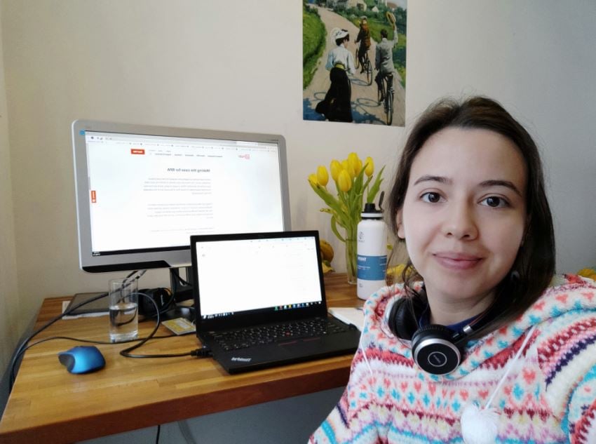 a photo of a woman taking a selfie and working from home