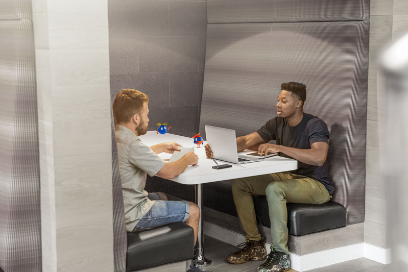 two people sitting in a booth