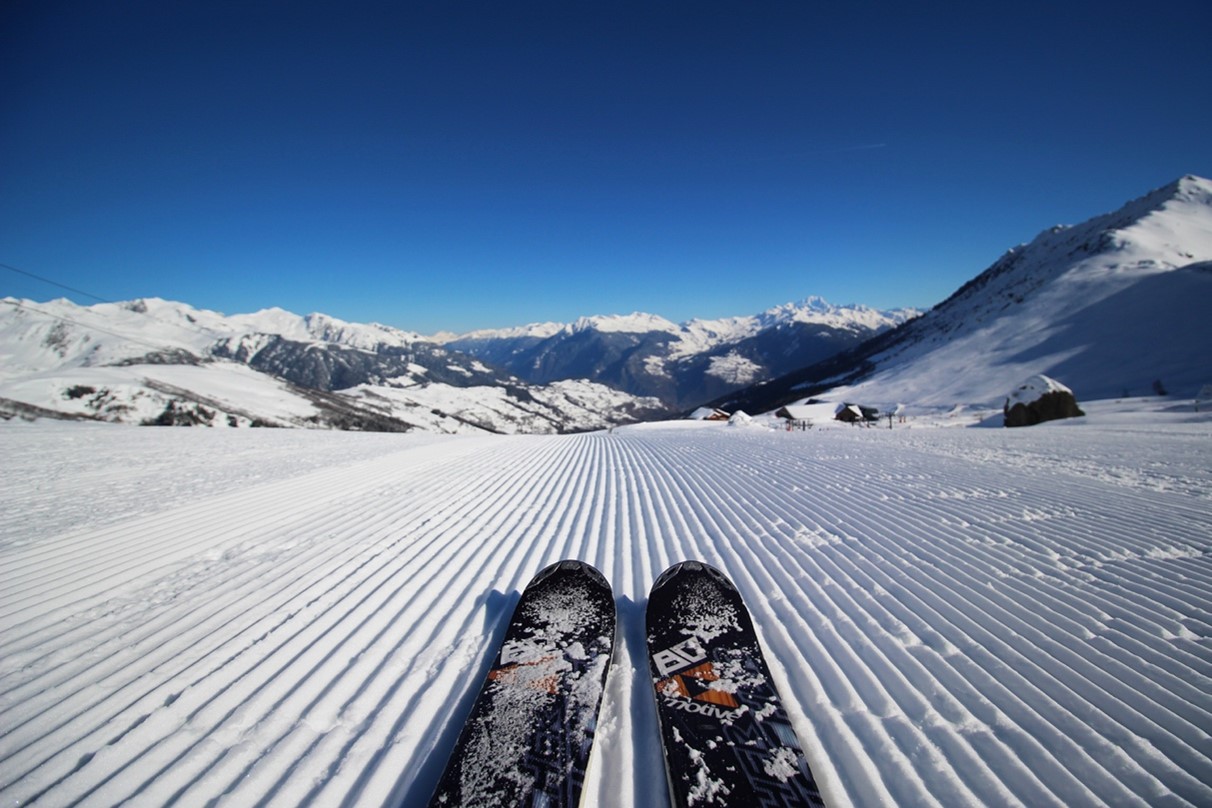 two skis positioned on a snowy slope, showcasing a serene winter scene.