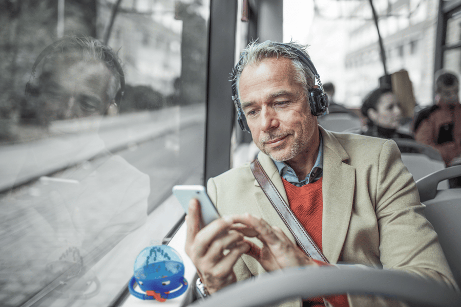 man on a bus listening to headphones