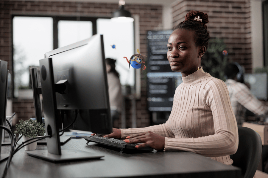 woman sitting at a desk using a computer