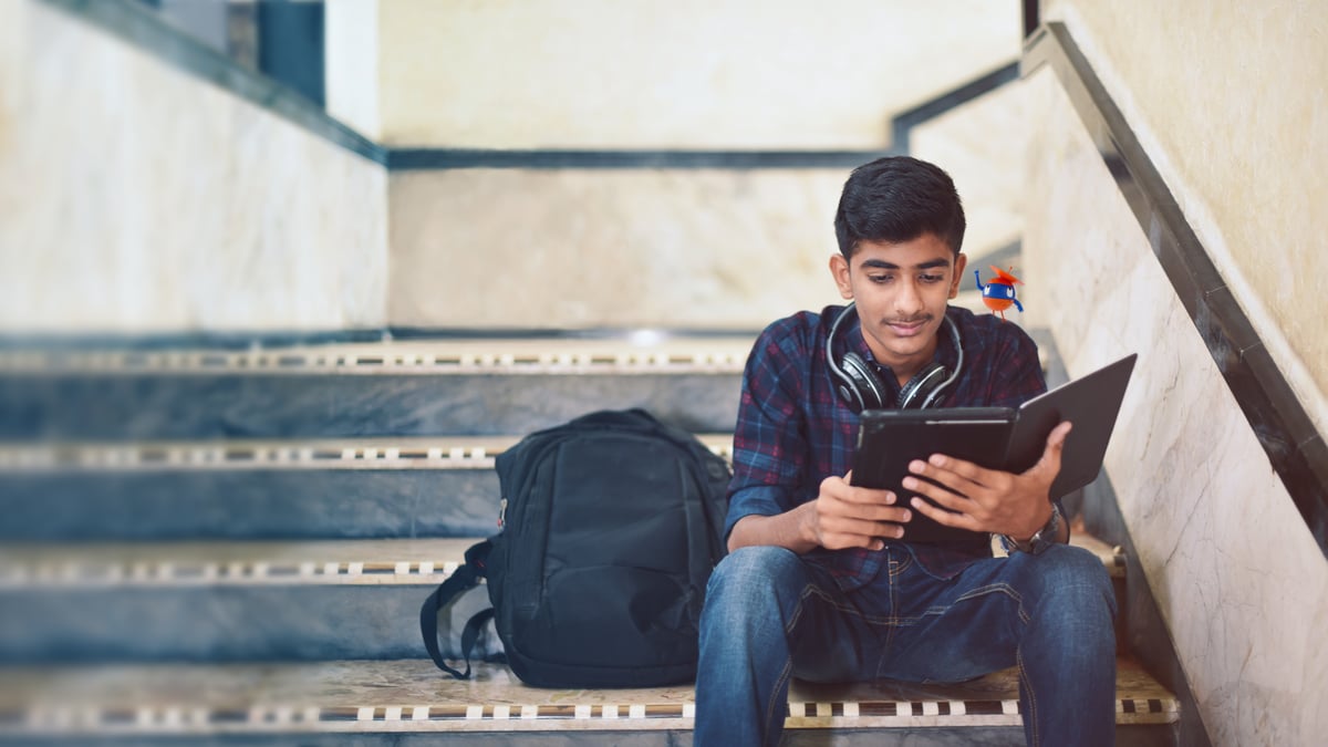 a photo of a student looking at his tablet device