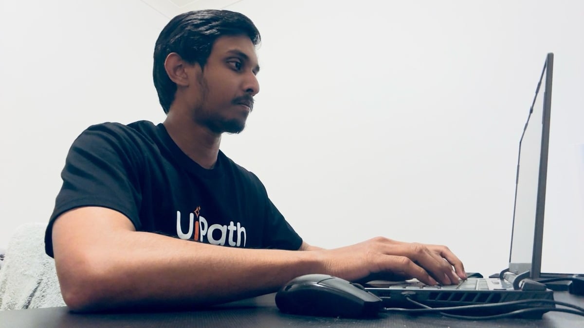an image of mewantha typing on laptop.