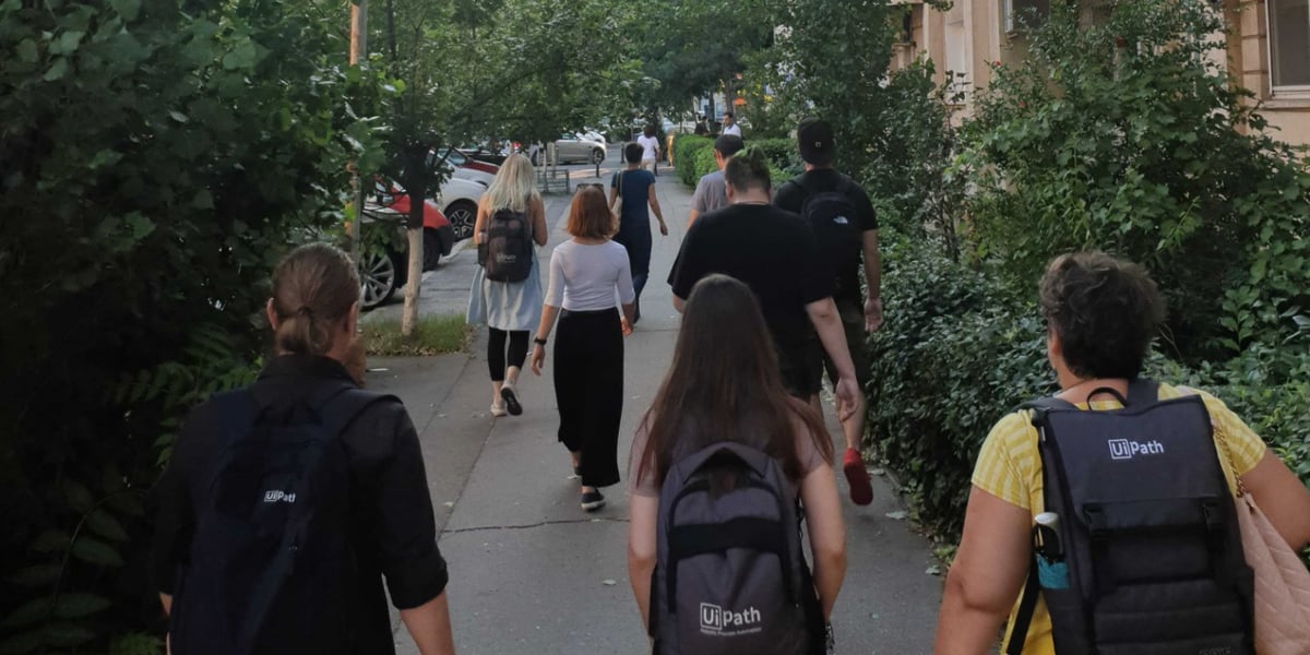 a photo of a group of people walking on the sidewalk