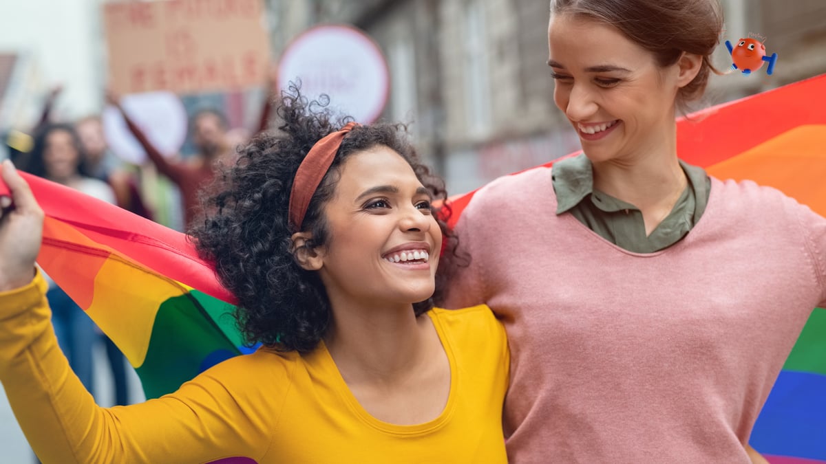 a photo of two women holding a pride flag