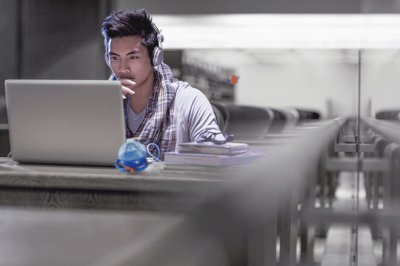 man sitting looking at a laptop