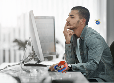 thinking man in front of computer