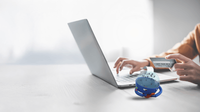 laptop on a desk with a robot