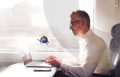 man on a train with a laptop; UiPath robot