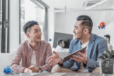 two men smiling and talking