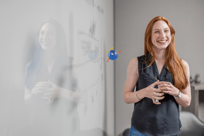 woman standing near whiteboard