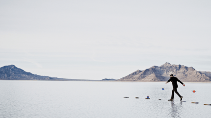 man walking on rocks over water