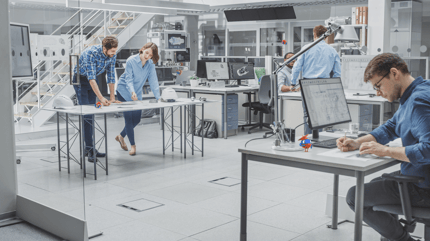 office workers in blue shirts in white office space