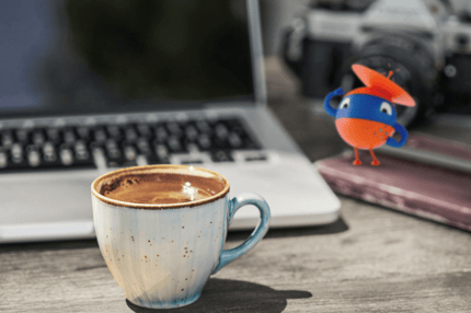 robot with a laptop and cup of coffee