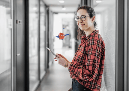 woman smiling with tablet and robot