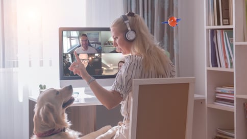 Women with her dog together making video conference with a group of people